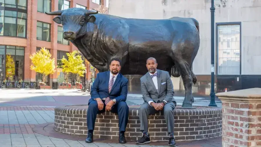 Frasier and Griffin sitting in front of a bull